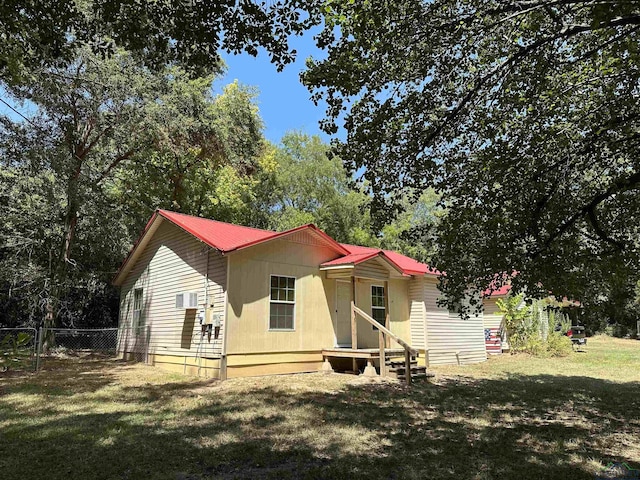 rear view of house featuring a lawn