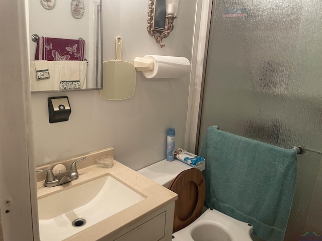 bathroom featuring vanity and a shower with door