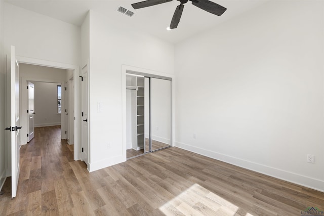 111 Mia Ln, Longview, TX 75604 - unfurnished bedroom with a closet, baseboards, light wood-type flooring, and a ceiling fan
