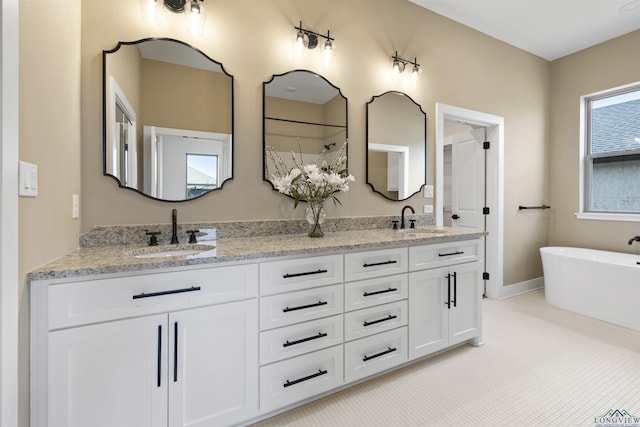 111 Mia Ln, Longview, TX 75604 - bathroom featuring double vanity and a soaking tub