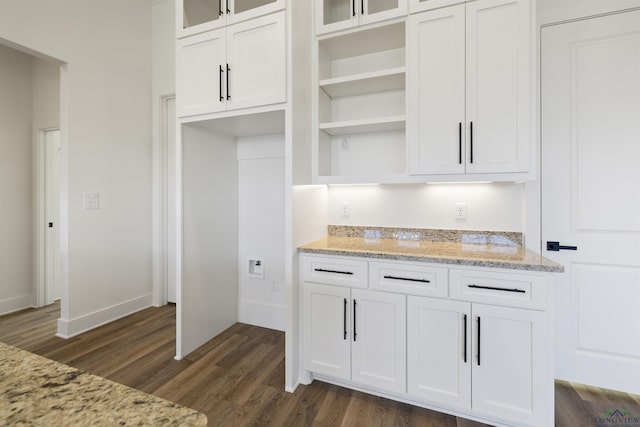 111 Mia Ln, Longview, TX 75604 - kitchen featuring dark wood-type flooring, white cabinetry, glass insert cabinets, open shelves, and light stone countertops