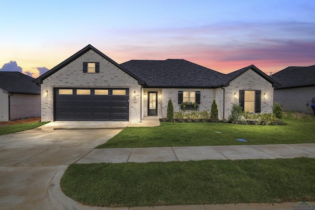 111 Mia Ln, Longview, TX 75604 - french country home with driveway, a front lawn, a garage, and brick siding