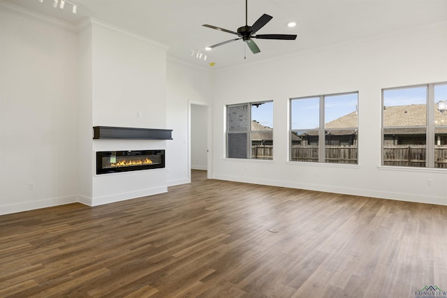111 Mia Ln, Longview, TX 75604 - unfurnished living room featuring crown molding, baseboards, a glass covered fireplace, wood finished floors, and a ceiling fan