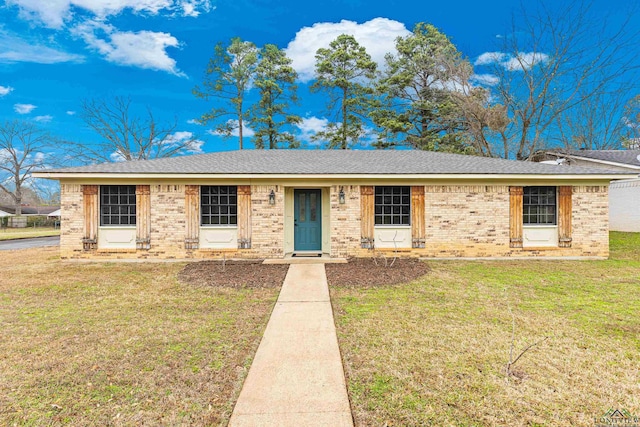 single story home with brick siding, roof with shingles, and a front lawn