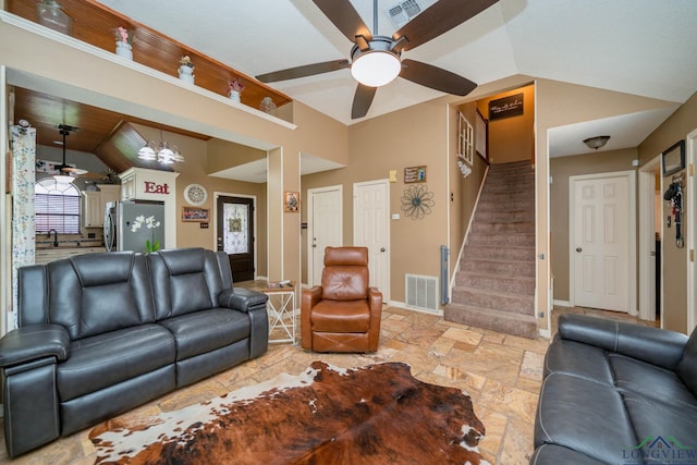 202 Mill Run Dr, Longview, TX 75604 - living room with stone tile floors, lofted ceiling, ceiling fan, stairway, and a chandelier