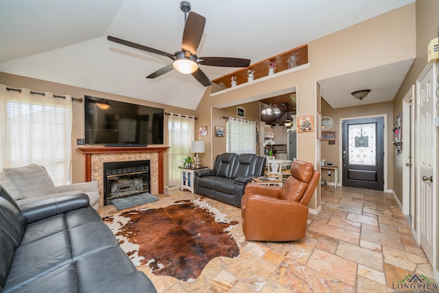 202 Mill Run Dr, Longview, TX 75604 - living area featuring lofted ceiling, a ceiling fan, stone tile floors, a chandelier, and healthy amount of natural light