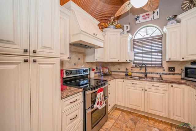 202 Mill Run Dr, Longview, TX 75604 - kitchen featuring appliances with stainless steel finishes, stone countertops, decorative backsplash, custom range hood, and stone tile floors