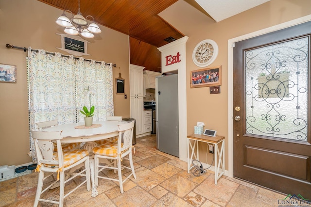 202 Mill Run Dr, Longview, TX 75604 - dining room with stone tile flooring, wooden ceiling, and a chandelier