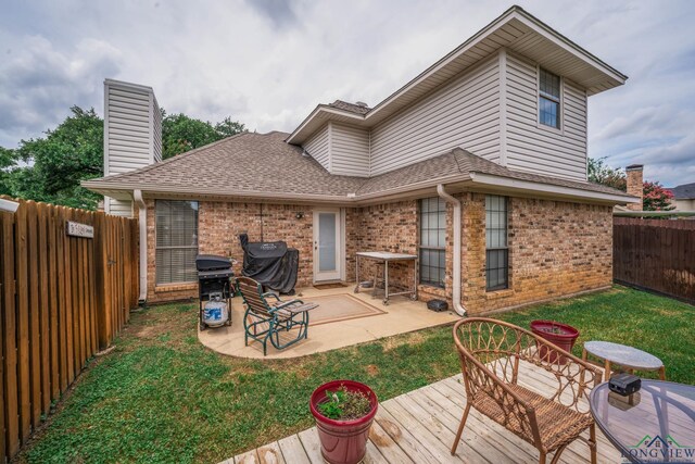 202 Mill Run Dr, Longview, TX 75604 - back of property with brick siding, a fenced backyard, roof with shingles, a patio area, and a deck