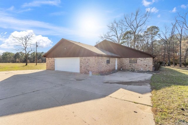 view of property exterior with a yard and a garage