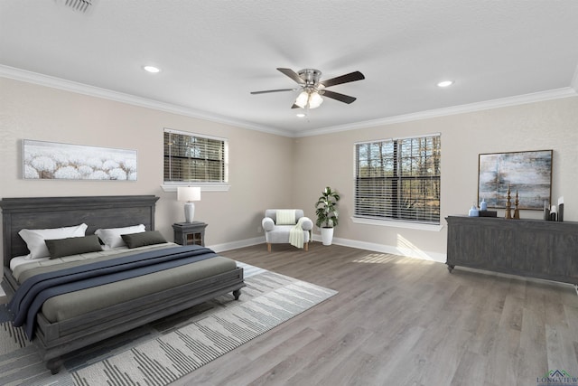 bedroom with ceiling fan, light hardwood / wood-style flooring, and ornamental molding