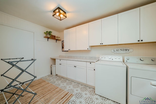114 Fairview Dr, Longview, TX 75604 - laundry room featuring washer and clothes dryer, cabinet space, and light tile patterned flooring