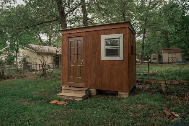 114 Fairview Dr, Longview, TX 75604 - view of shed featuring a fenced backyard and entry steps