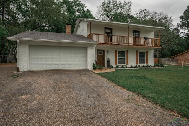 114 Fairview Dr, Longview, TX 75604 - view of front facade with asphalt driveway, a balcony, brick siding, a chimney, and a garage