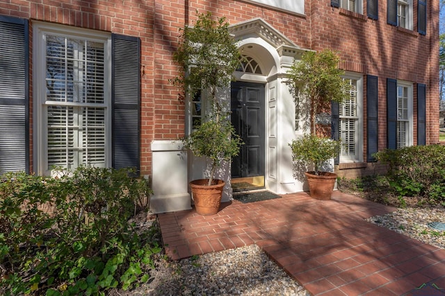 property entrance with brick siding