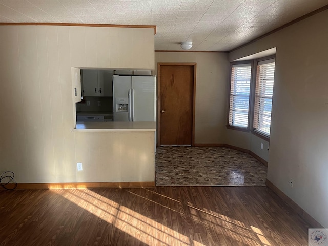 interior space featuring dark hardwood / wood-style flooring and crown molding