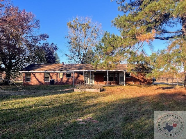 rear view of house with a yard