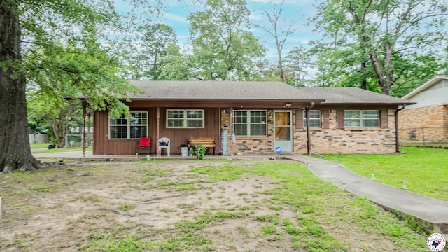 3324 Cherry St, Texarkana, AR 71854 - view of front facade with brick siding, a front yard, and roof with shingles
