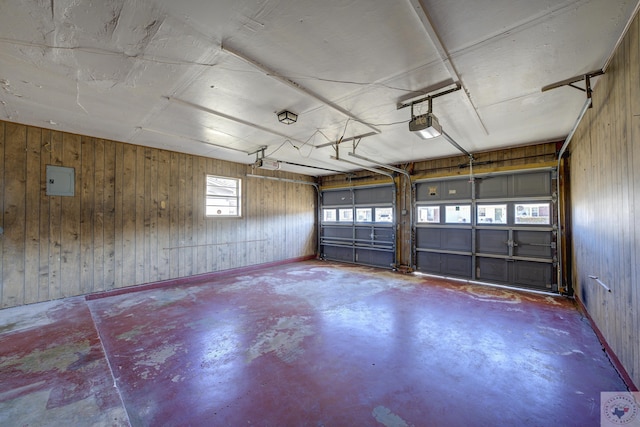 garage with a garage door opener, wooden walls, and electric panel