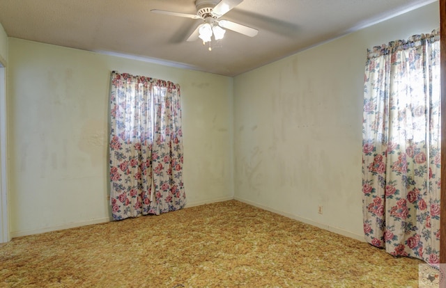 carpeted empty room featuring ceiling fan