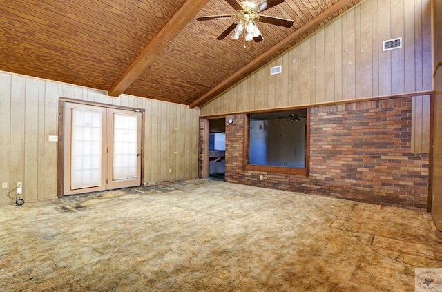 unfurnished living room featuring high vaulted ceiling, wooden walls, carpet floors, ceiling fan, and brick wall