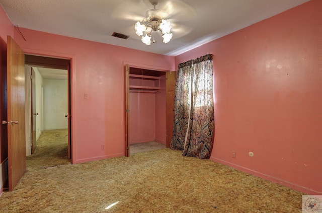 unfurnished bedroom with light colored carpet, a closet, and ceiling fan