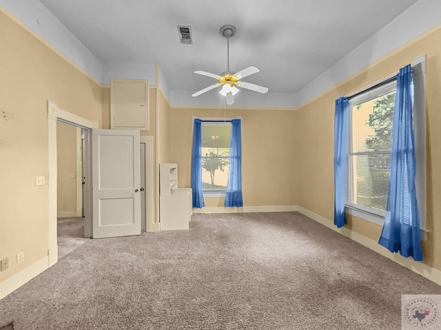 carpeted empty room featuring ceiling fan