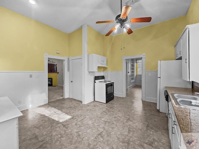 kitchen featuring sink, white cabinetry, ceiling fan, and electric stove