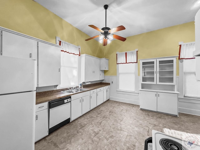 kitchen with sink, white appliances, and white cabinets