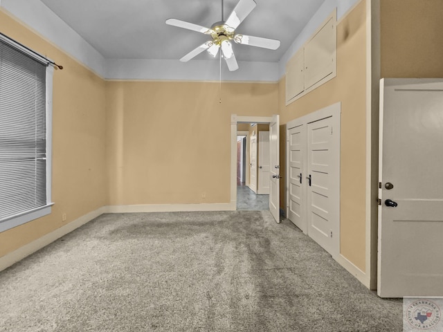 carpeted spare room with ceiling fan