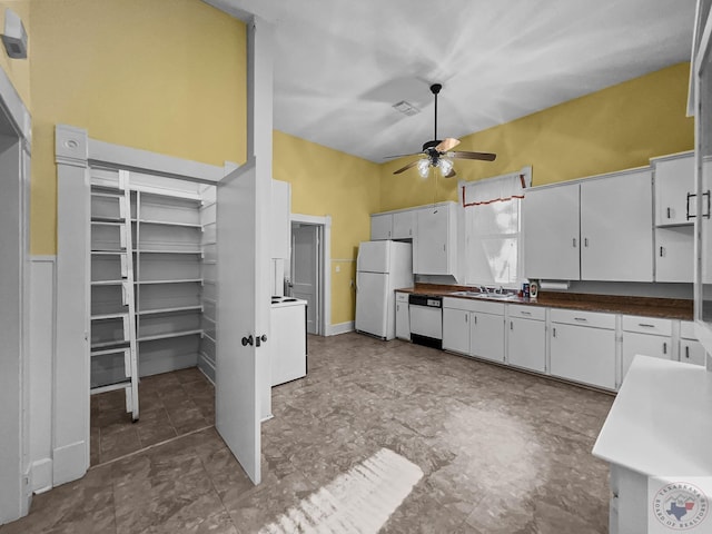 kitchen featuring white appliances, white cabinets, sink, a high ceiling, and ceiling fan