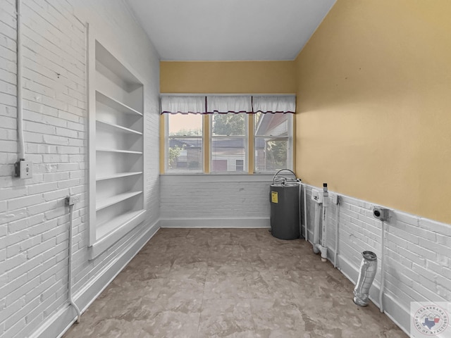 laundry area featuring built in shelves and hookup for an electric dryer