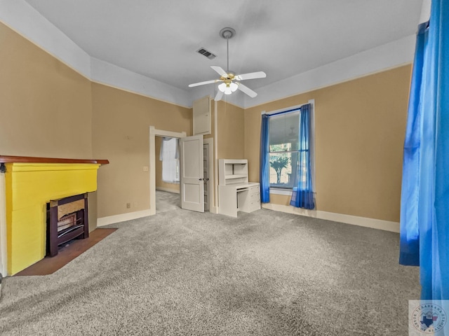 unfurnished living room featuring ceiling fan and dark carpet