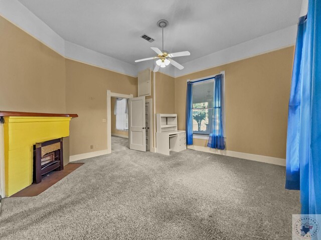 unfurnished living room featuring ceiling fan and dark carpet