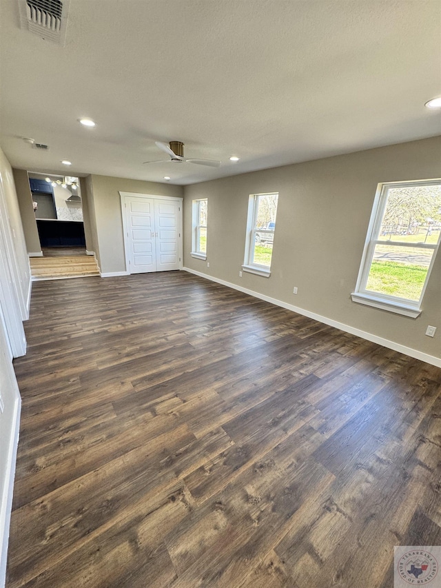 unfurnished living room featuring ceiling fan, recessed lighting, visible vents, baseboards, and dark wood-style floors