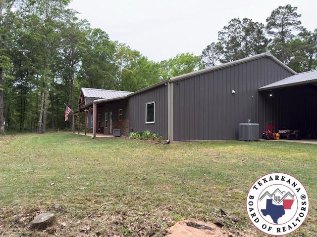 3059 Mc 22, Fouke, AR 71837 - view of property exterior featuring a lawn and a metal roof