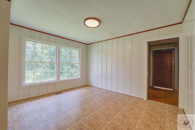 unfurnished room with crown molding