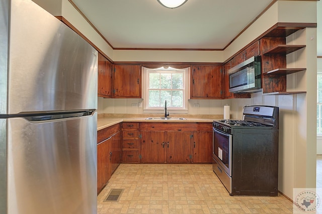 kitchen featuring sink, crown molding, and appliances with stainless steel finishes