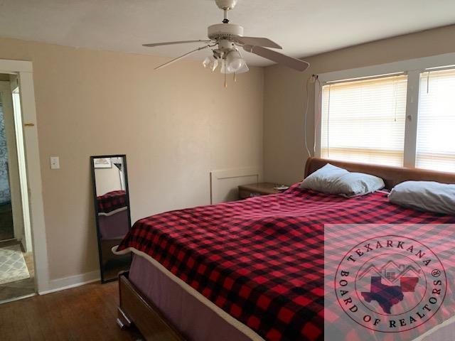 3812 Elizabeth St, Texarkana, TX 75501 - bedroom with wood finished floors, ceiling fan, and baseboards