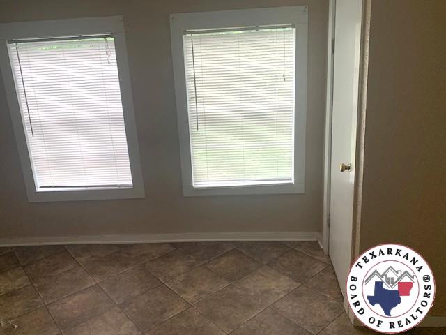 3812 Elizabeth St, Texarkana, TX 75501 - spare room with baseboards and plenty of natural light