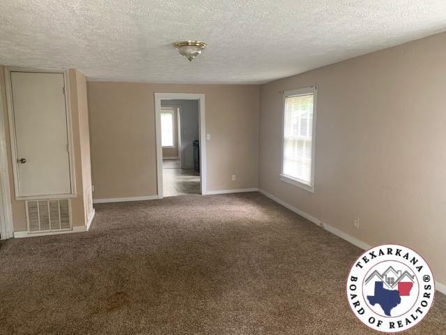 3812 Elizabeth St, Texarkana, TX 75501 - carpeted empty room with a textured ceiling and baseboards