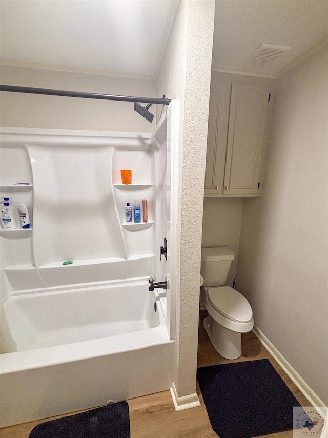 111 Oak St, New Boston, TX 75570 - bathroom with toilet, shower / bathing tub combination, wood finished floors, baseboards, and visible vents