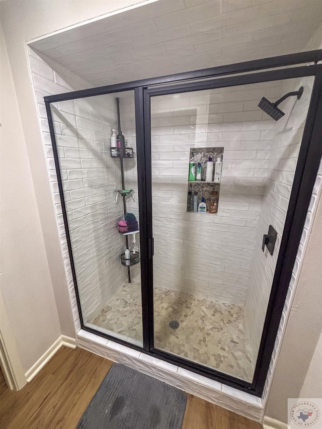 111 Oak St, New Boston, TX 75570 - bathroom with a stall shower, baseboards, and wood finished floors