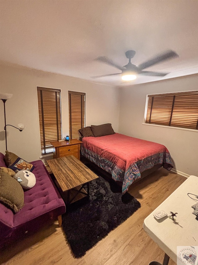 111 Oak St, New Boston, TX 75570 - bedroom featuring ceiling fan and wood finished floors