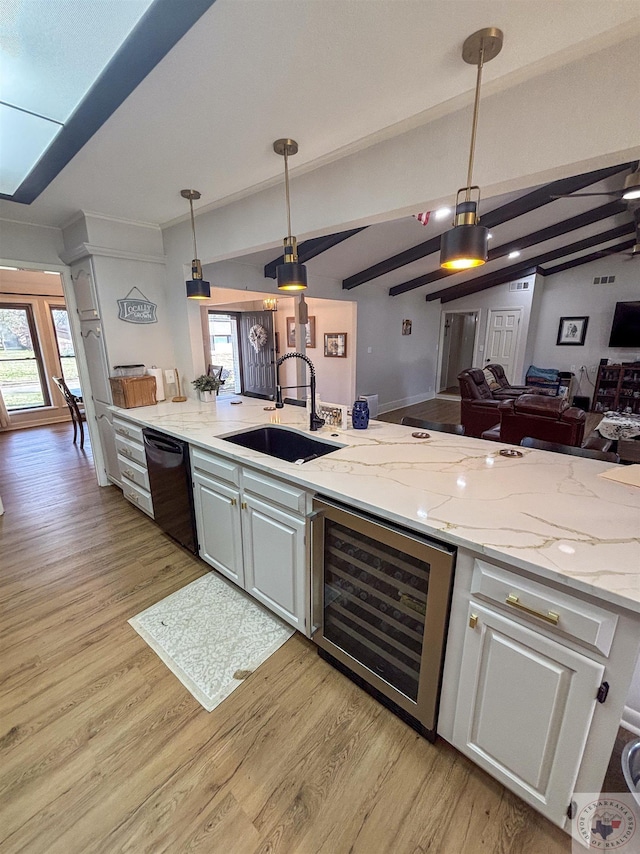 111 Oak St, New Boston, TX 75570 - kitchen featuring wine cooler, black dishwasher, a sink, open floor plan, and pendant lighting