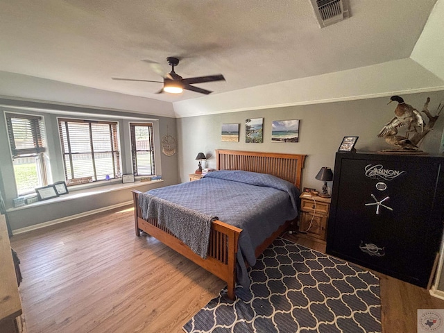 111 Oak St, New Boston, TX 75570 - bedroom with a ceiling fan, wood finished floors, a textured ceiling, baseboards, and visible vents