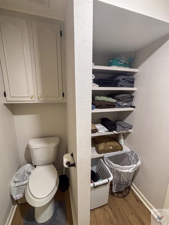 111 Oak St, New Boston, TX 75570 - bathroom featuring baseboards, wood finished floors, and toilet