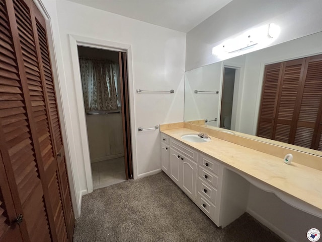 416 W Greenfield Dr, Wake Village, TX 75503 - bathroom with a closet, vanity, carpet flooring, and baseboards