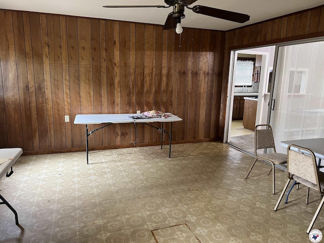 416 W Greenfield Dr, Wake Village, TX 75503 - unfurnished office with light flooring, wood walls, ceiling fan, a sink, and baseboards