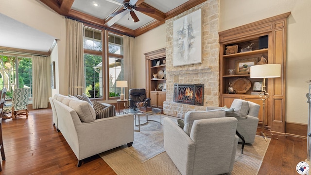6804 Springwood Cir, Texarkana, TX 75503 - living room with ceiling fan, a towering ceiling, a fireplace, hardwood / wood-style floors, and beamed ceiling